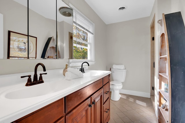 bathroom featuring tile patterned flooring, vanity, and toilet