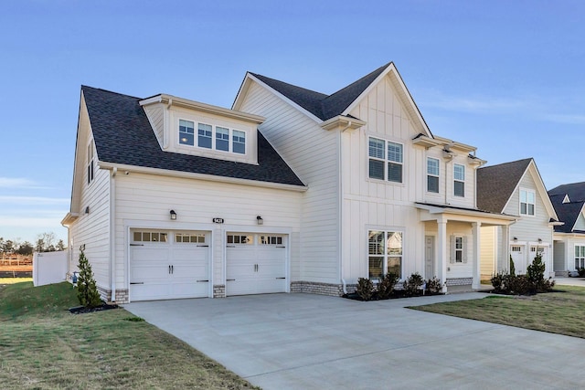 view of front of home featuring a front yard and a garage