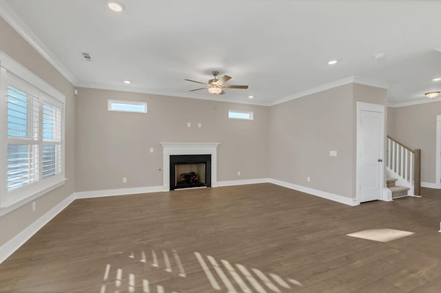 unfurnished living room with ceiling fan, crown molding, and dark wood-type flooring