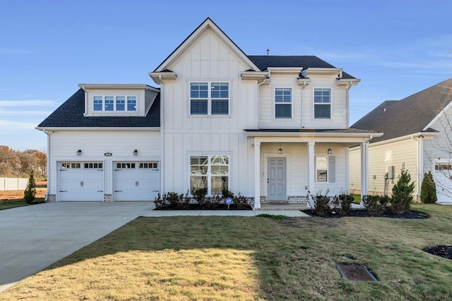 view of front of property featuring covered porch, a front yard, and a garage