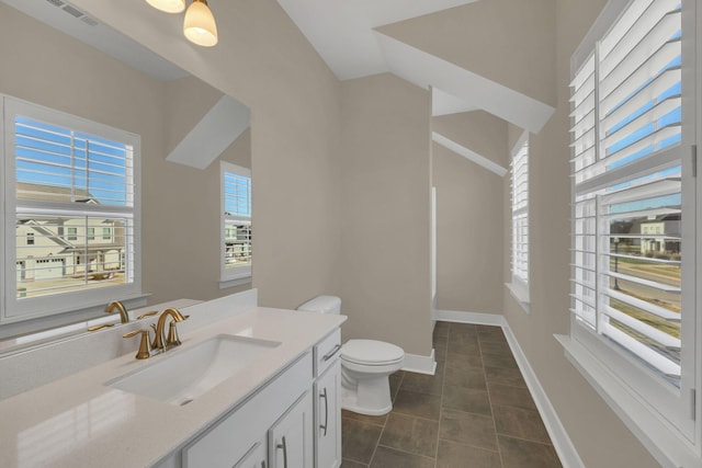 bathroom featuring tile patterned flooring, vanity, and toilet