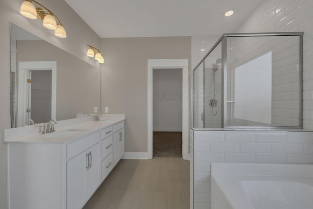 bathroom featuring tile patterned flooring, vanity, and plus walk in shower