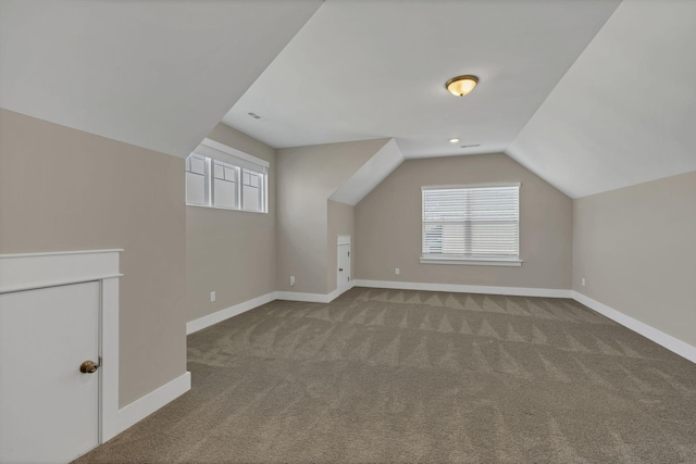 bonus room featuring carpet flooring and vaulted ceiling