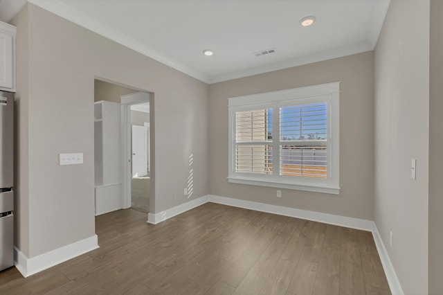 interior space with light hardwood / wood-style floors and ornamental molding