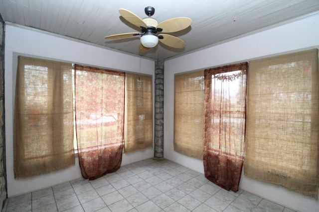 tiled empty room with ceiling fan