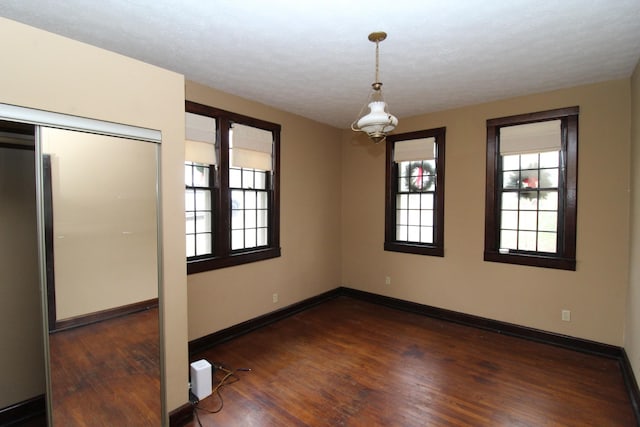 spare room featuring dark hardwood / wood-style flooring