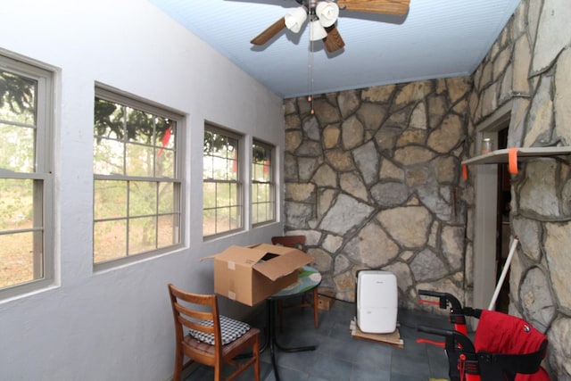 sunroom / solarium with plenty of natural light and ceiling fan