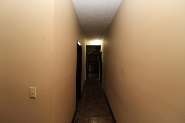 corridor with a textured ceiling