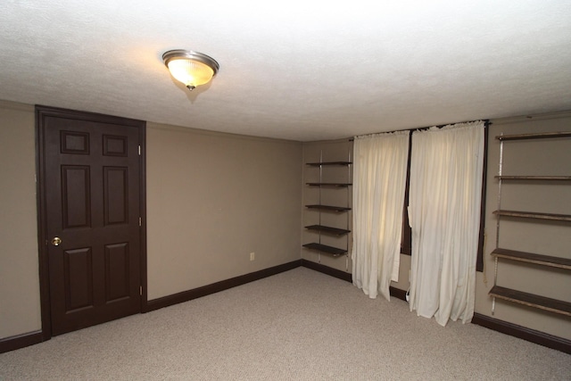 unfurnished bedroom with a textured ceiling and light carpet