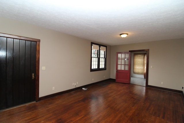 interior space featuring dark hardwood / wood-style flooring and a textured ceiling