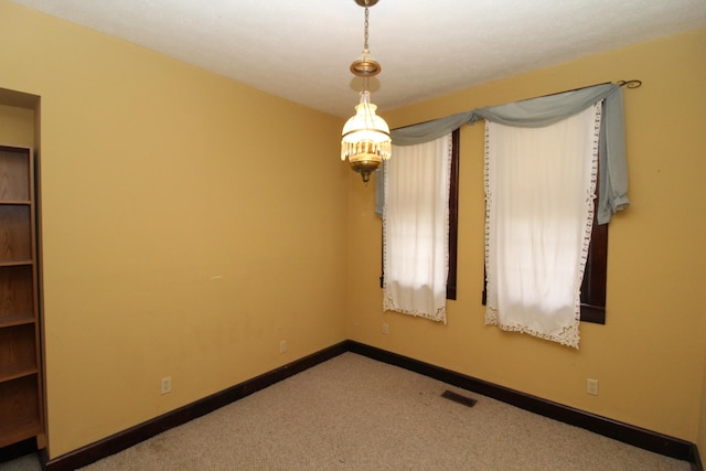 unfurnished room featuring light colored carpet