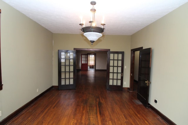 unfurnished room with dark hardwood / wood-style flooring and french doors