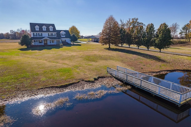 exterior space with a water view and a lawn