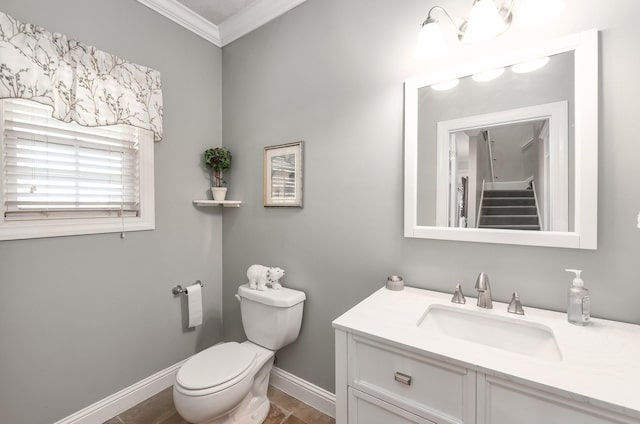 bathroom featuring vanity, toilet, and crown molding