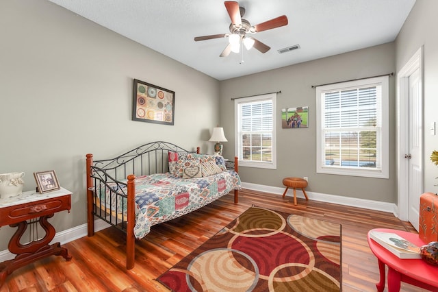 bedroom with ceiling fan and wood-type flooring