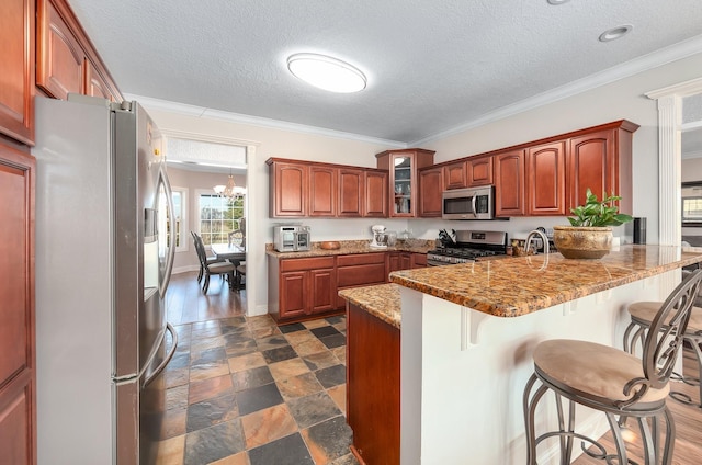 304 China Grove Rd, Rutherford, TN 38369 - kitchen featuring appliances with stainless steel finishes, a peninsula, a kitchen breakfast bar, a textured ceiling, and glass insert cabinets