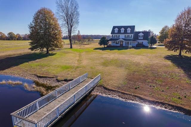 exterior space featuring a yard, a rural view, and a water view