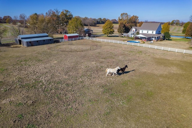 view of yard featuring a rural view and an outdoor structure