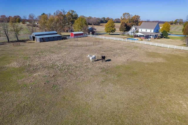 view of yard with an outbuilding and a rural view