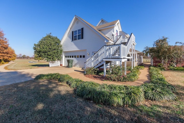 view of home's exterior featuring a lawn and a garage