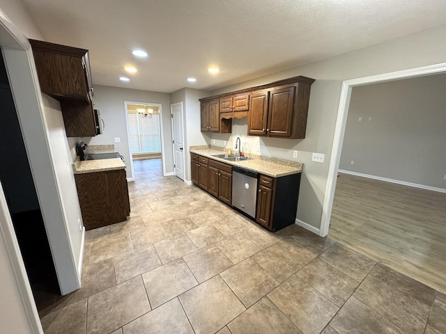 kitchen featuring dark brown cabinetry, stainless steel appliances, light hardwood / wood-style flooring, and sink