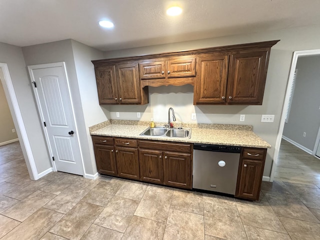 kitchen featuring dishwasher, dark brown cabinetry, and sink