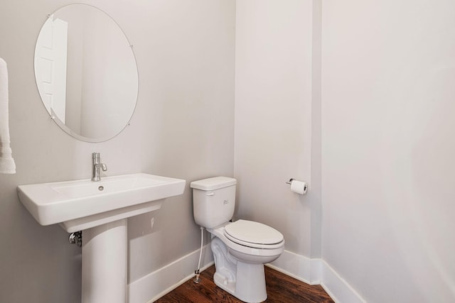 bathroom featuring hardwood / wood-style floors and toilet