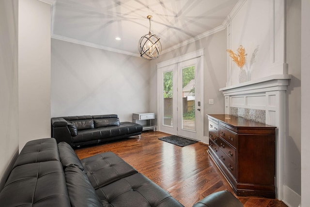 living room featuring a notable chandelier, crown molding, and dark wood-type flooring