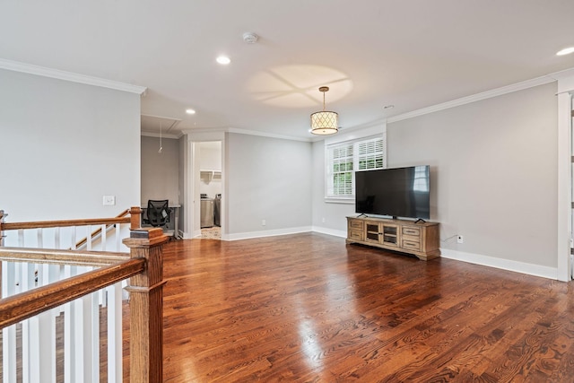 living room featuring washer / clothes dryer, dark hardwood / wood-style floors, and ornamental molding