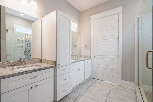 bathroom featuring vanity and a shower with door