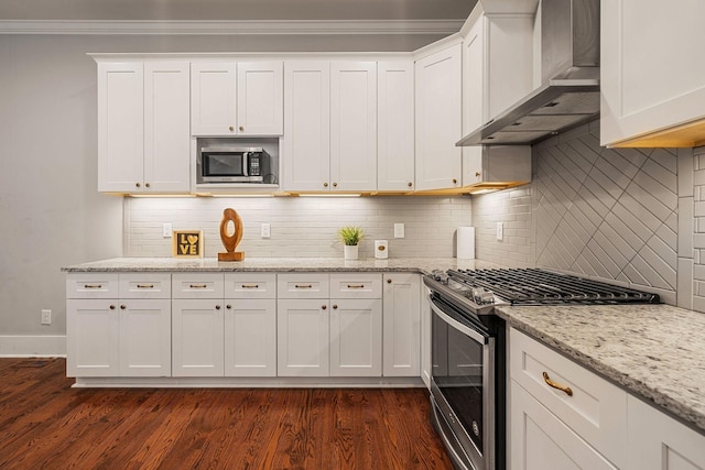 kitchen with wall chimney exhaust hood, stainless steel appliances, dark hardwood / wood-style floors, backsplash, and white cabinets