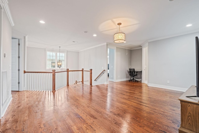 unfurnished living room with hardwood / wood-style flooring, crown molding, and a chandelier