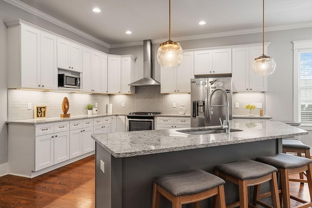 kitchen with pendant lighting, wall chimney exhaust hood, dark hardwood / wood-style floors, appliances with stainless steel finishes, and white cabinetry