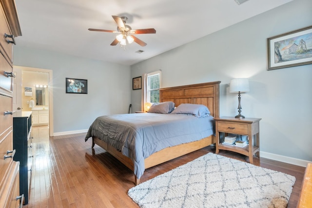 bedroom with connected bathroom, ceiling fan, and hardwood / wood-style floors