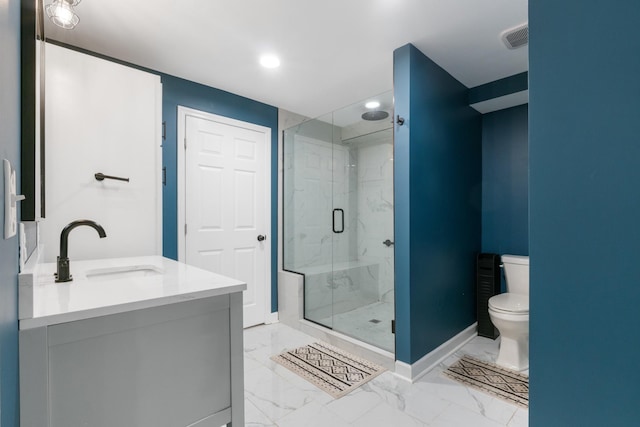 bathroom featuring vanity, toilet, and a shower with door