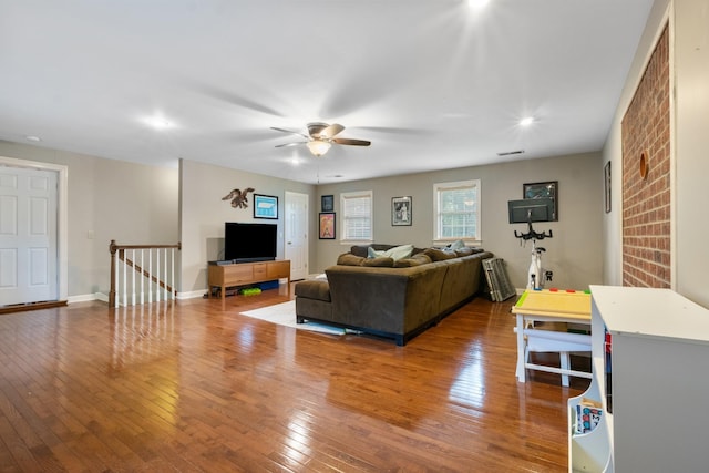 living room with ceiling fan and wood-type flooring