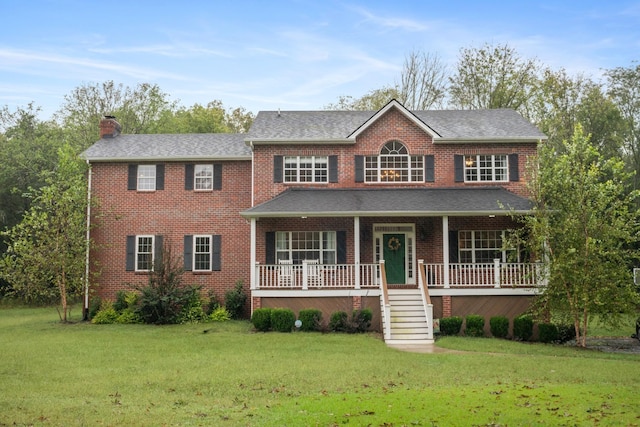 view of front of property with covered porch and a front yard