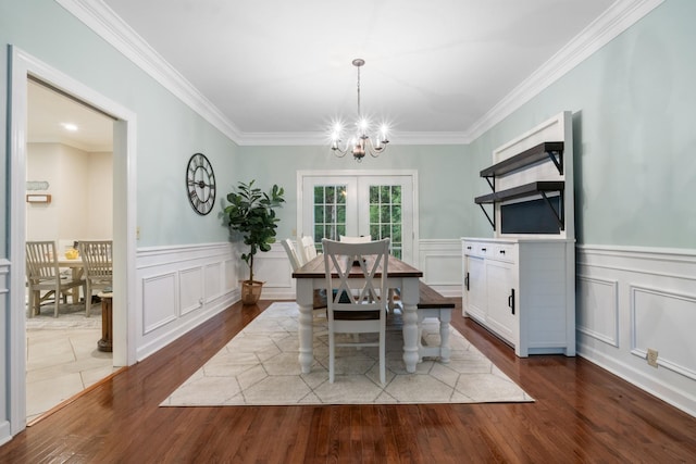 dining space with a chandelier, dark hardwood / wood-style flooring, and crown molding