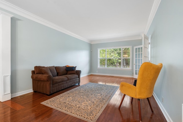 living room with wood-type flooring and ornamental molding