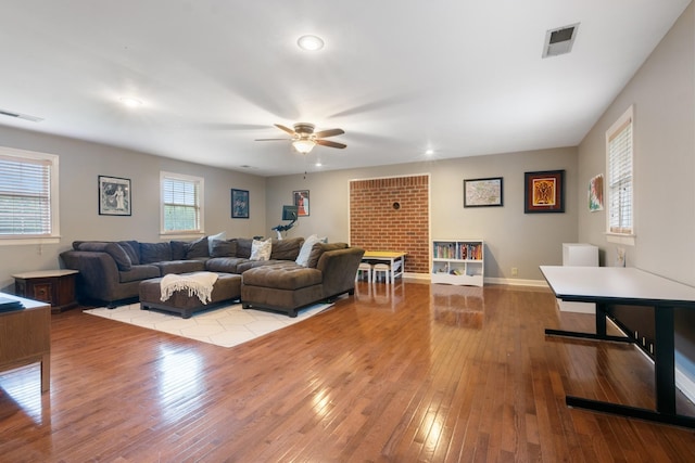 living room with light wood-type flooring and ceiling fan