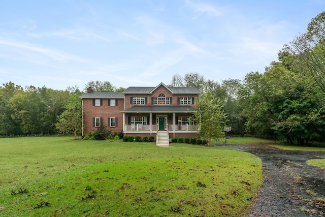 view of front of house with a porch and a front yard