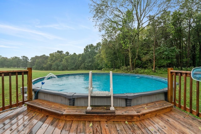 view of swimming pool with a lawn, a wooden deck, and a hot tub