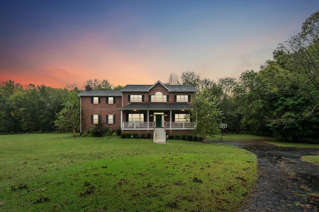 view of front facade featuring a yard and covered porch