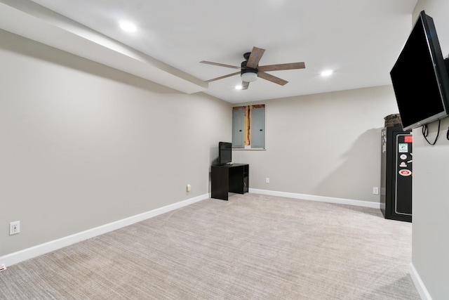 exercise room featuring ceiling fan and light carpet