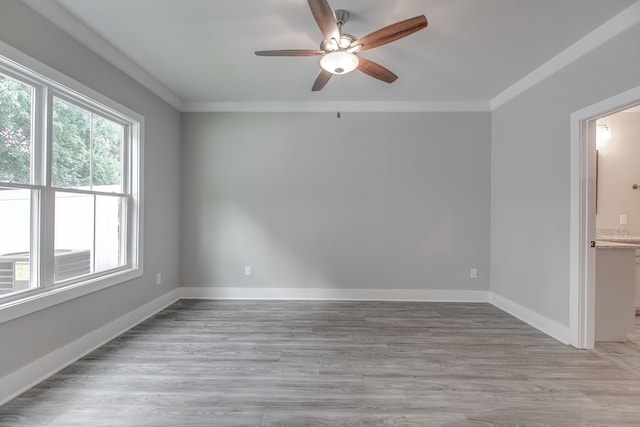 spare room featuring crown molding, ceiling fan, and light hardwood / wood-style floors