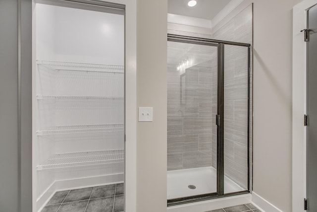 bathroom with tile patterned flooring and walk in shower