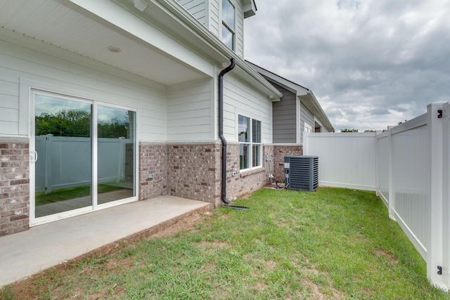 view of yard featuring central AC unit and a patio area