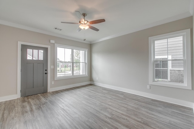 entrance foyer featuring crown molding, ceiling fan, and light wood-type flooring