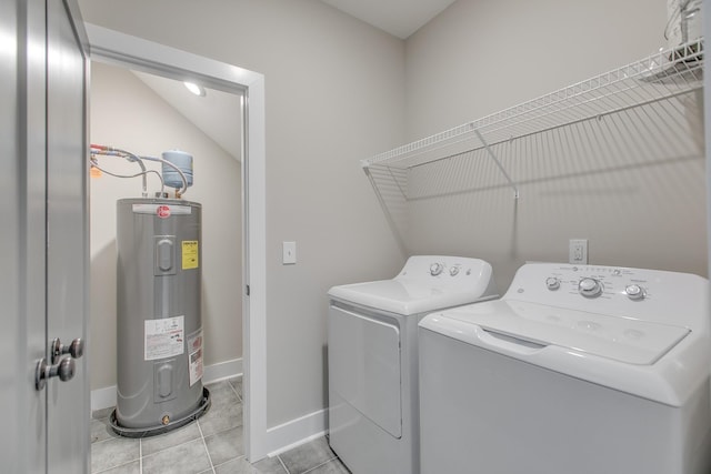 clothes washing area with light tile patterned floors, electric water heater, and washing machine and dryer