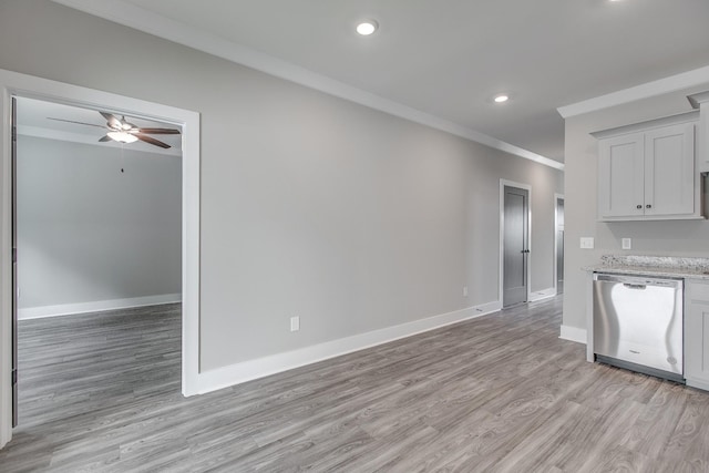 kitchen featuring white cabinetry, crown molding, stainless steel dishwasher, and light hardwood / wood-style floors